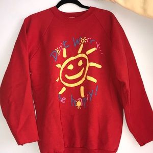 red sweatshirt “don’t worry be happy”